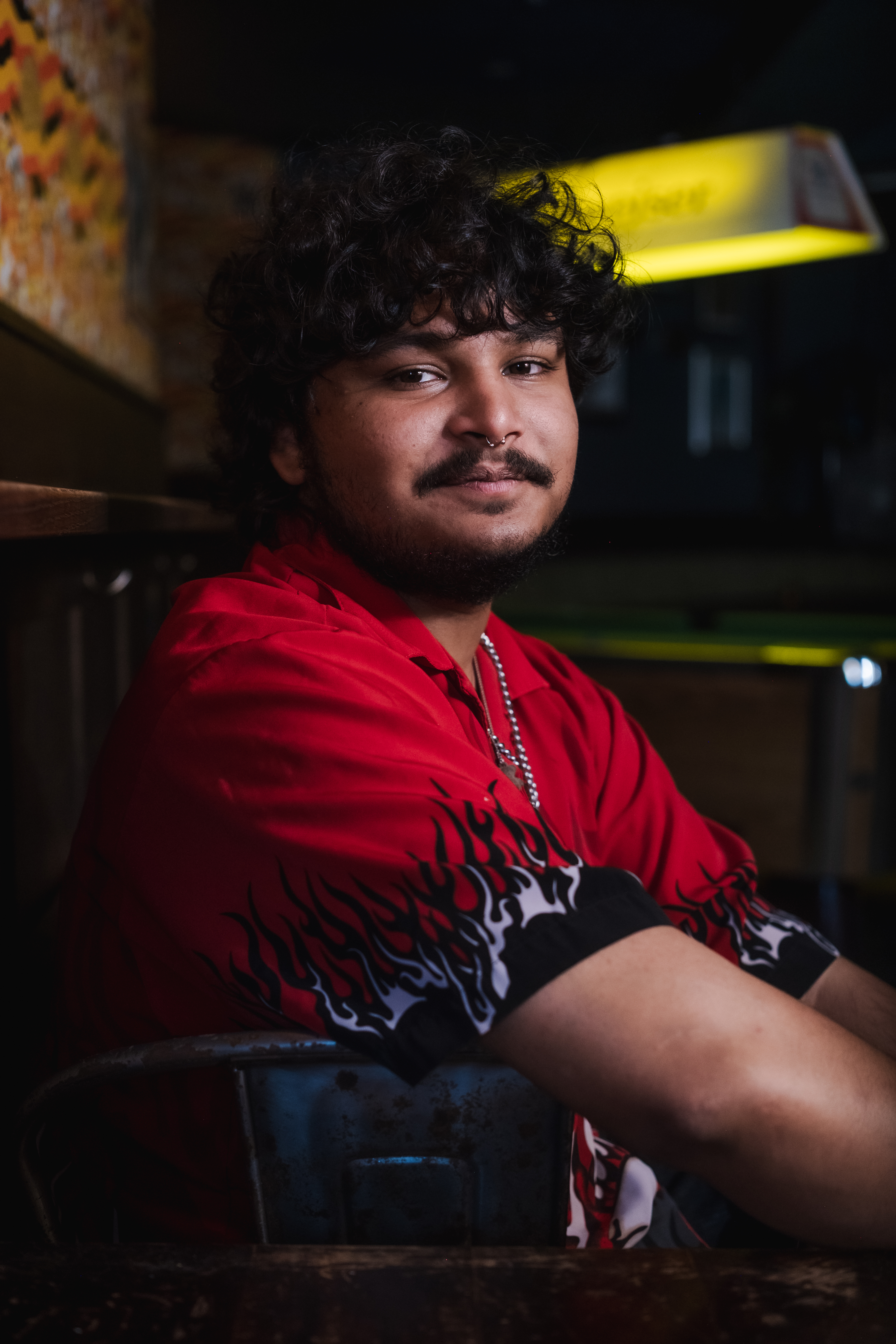 Portrait of Vidhu Kota seated in a Brooklyn apartment